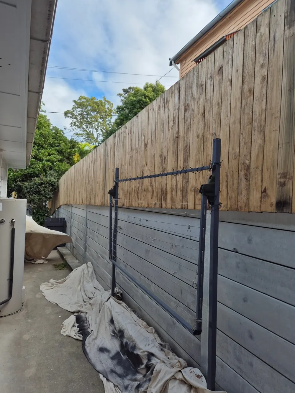 Timber fence before: weathered bare timber